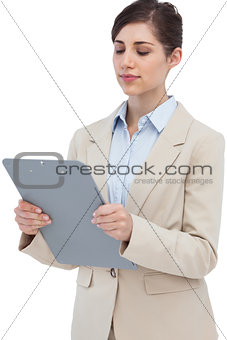 Serious businesswoman with clipboard