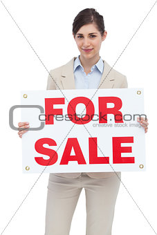 Businesswoman with for sale sign