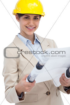 Smiling young architect holding plan