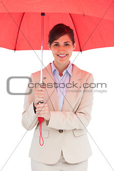 Cheerful young businesswoman with red umbrella