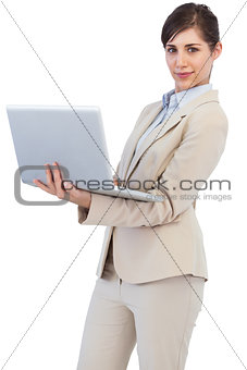 Confident young businesswoman with laptop