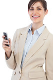 Cheerful businesswoman posing with phone on right hand