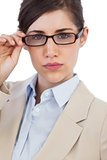 Serious businesswoman holding her glasses
