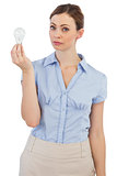 Thoughtful businesswoman with light bulb