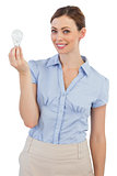 Businesswoman holding a light bulb