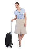 Elegant businesswoman posing with suitcase
