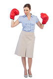 Attractive businesswoman posing with boxing gloves