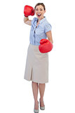 Cheerful businesswoman with red boxing gloves