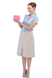 Happy businesswoman with piggy bank