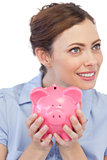Businesswoman holding her piggy bank