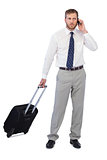 Handsome businessman posing with suitcase and phone
