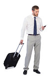 Elegant businessman with phone and suitcase