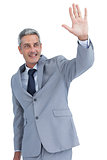 Handsome businessman waving