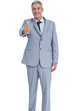 Positive businessman showing thumb up