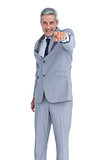 Confident businessman posing and pointing at camera