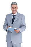 Happy businessman with tablet pc