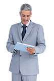 Happy businessman using tablet pc