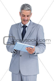 Happy businessman using tablet pc