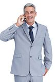 Happy businessman answering phone
