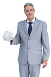 Attractive businessman holding gift