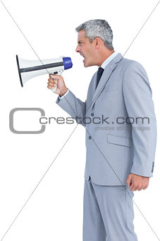 Businessman shouting in loudspeaker
