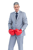Furious businessman posing with boxing gloves
