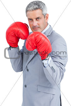 Tough businessman with boxing gloves