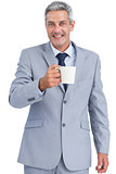 Cheerful businessman holding mug