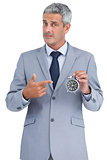 Businessman holding alarm clock