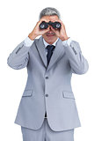 Businessman observing through binoculars