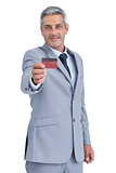 Confident businessman holding credit card
