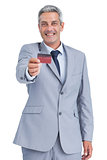 Handsome businessman holding credit card