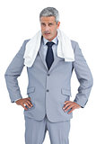 Frowning businessman posing with white towel