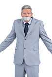Businessman with adhesive tape on mouth