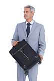 Handsome businessman carrying suitcase