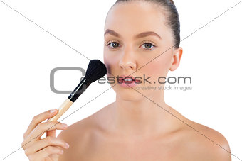 Model applying face powder with brush