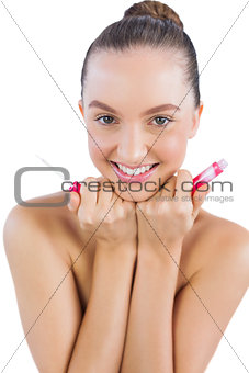 Cheerful young model with lip gloss