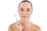 Surprised woman with toothbrush