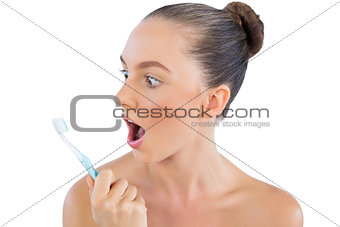 Young model looking at her toothbrush