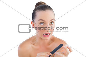 Nervous woman using nail file