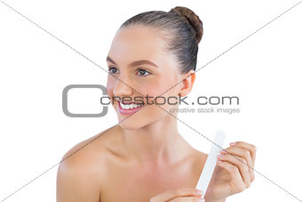 Smiling woman with nail file