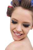 Model wearing hair curlers smiling in close up