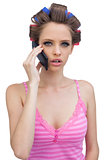 Young lady in hair curlers having a phone call