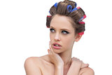 Seductive lady in hair rollers posing and looking away
