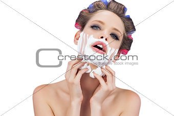 Sensual model with shaving foam looking at camera
