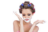 Interrogative woman posing with shaving foam