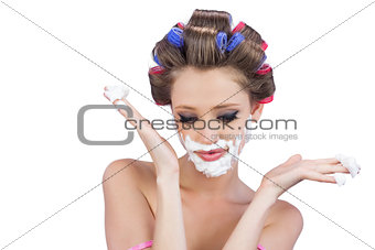 Interrogative woman posing with shaving foam