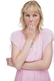 Blond woman putting her hand on her mouth