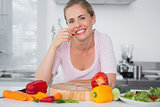 Cheerful woman eating vegetables