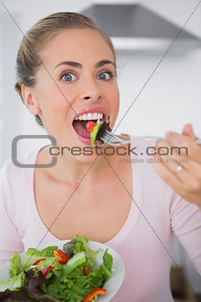 Attractive blonde eating salad